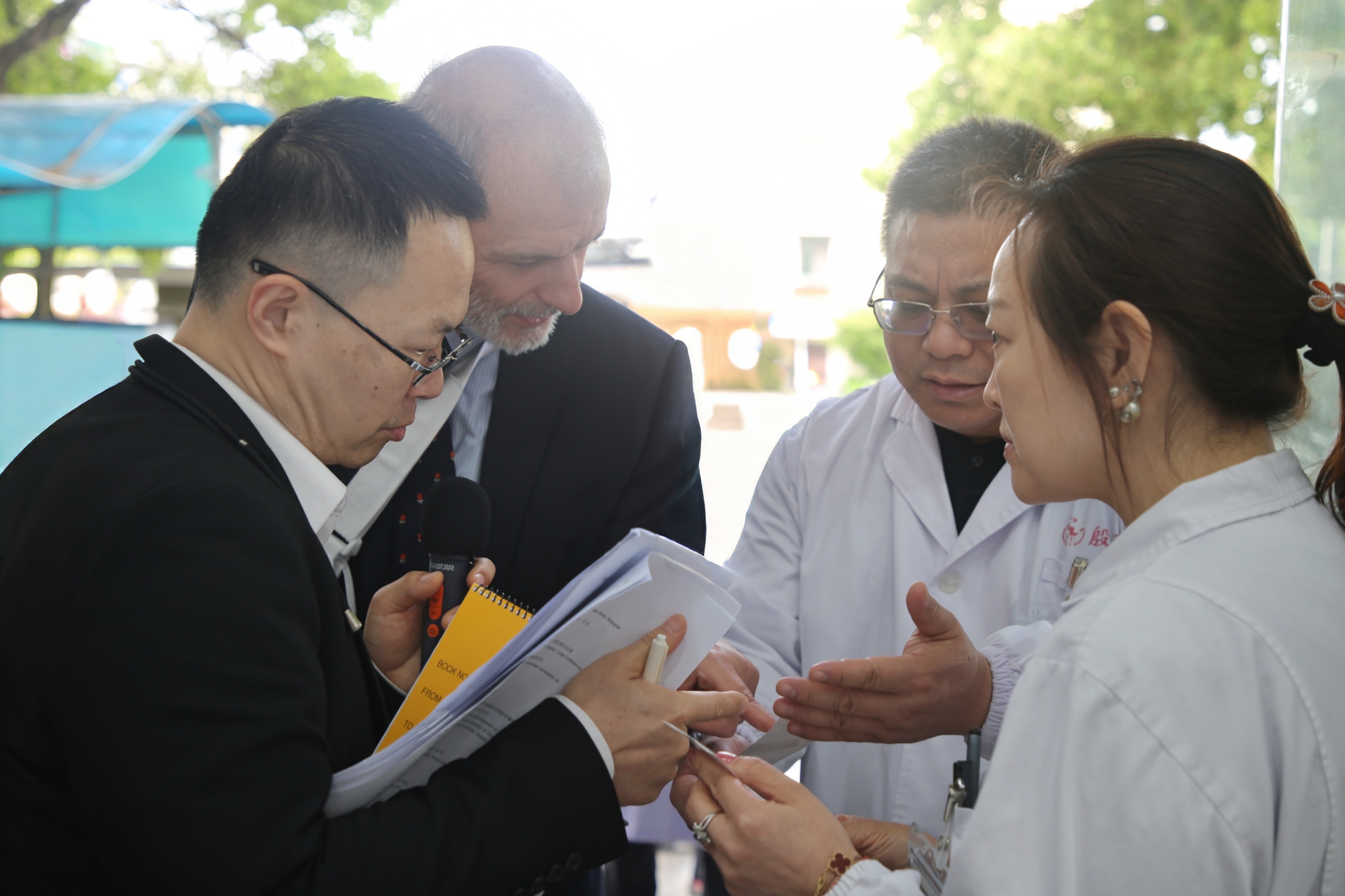 A WONCA assessor reviews documentation with Yinhang Community Health Service Centre staff during the on-site visit